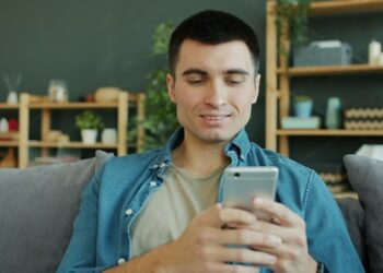 Man using smartphone smiling