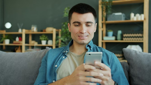 Man using smartphone smiling